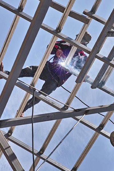 view from below of person installing commercial roof bowling